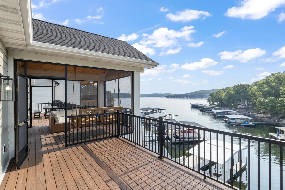 A serene lake view with deck furniture and nearby boathouses, inviting guests to relax, fish, or enjoy sunset views. The setting is ideal for unwinding after water adventures or gathering by the lakeside in the evening.